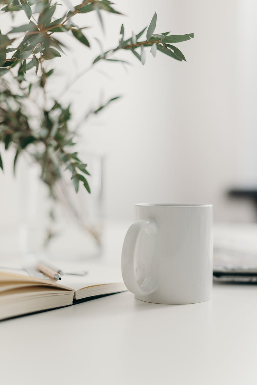 white ceramic mug on table